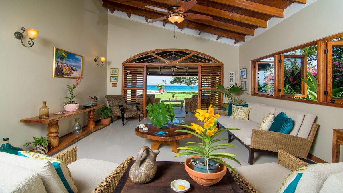Living room looking out toward the ocean at Sand Pebbles Villa.